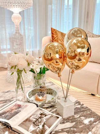 Golden Balloons Sculpture Decor placed in a contemporary, luxurious living room.