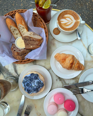 A Creamy Blueberry Pancake Candle placed among Parisian desserts.