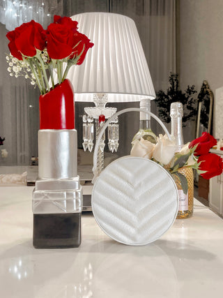 Luxurious Lipstick Resin Vase - XXL next to a Freya Resin Vase with blooming white roses.