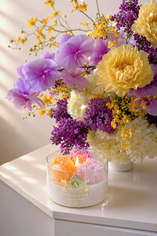 Peony Bouquet Candle next to a lush bouquet of blooming peonies