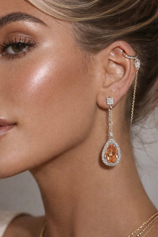 Arya Halo Pear Cut earrings worn in a multi-million dollar mansion gala