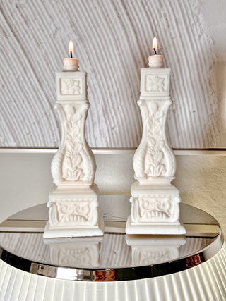  Stair Balusters Candle Set of 2 placed atop a reflective, luxurious lamp shade.