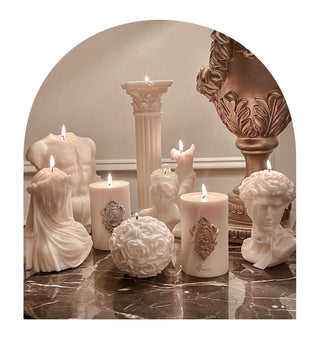 Anais Candle's Greek Sculpture Candle Collection on a marble table.