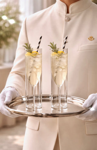 High end hotel's butler holding a tray with two Maeve Double Layered Glass Cups.