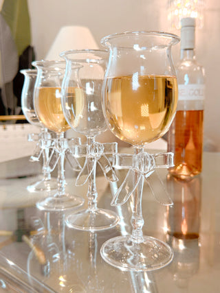 Charlotte Bow Wine Glass Cup Set of 2 next to a beautiful bottle of wine.