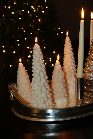 Timeless Pine Tree Candle Set of 2 - Extra Tall next to luxurious, lit pillar candles.