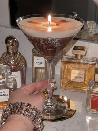 A woman holding a Lux Espresso Martini Candle.