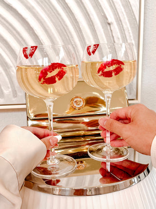 A couple toasting with the ‘Kiss Me, If You Adore Me’ Glass Cup Set.