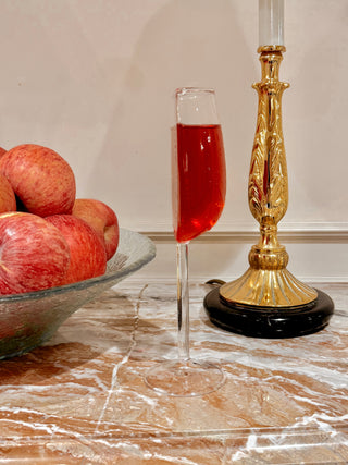 A single ‘We Are One’ Wine Glass Cup atop a marble credenza.