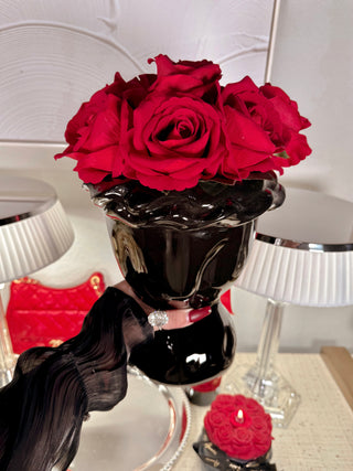 A woman decorating a Cecilia Ceramic Bouquet Vase with a rose bouquet.