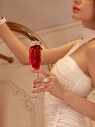 A woman holding the ‘We Are One’ Wine Glass Cup full of wine.