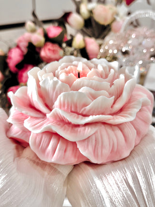 A woman with silk sleeves delicately holding a Blooming Peony Candle - XXL.