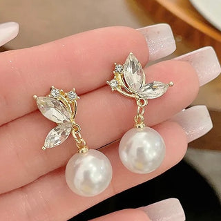 Ada Pearl Earrings (Free Gift Offer!) held in a woman's hand.