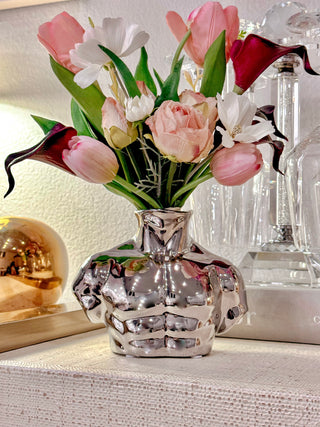 Alexander Male Bust Ceramic Vase - Silver Electroplated on top of a luxurious credenza.