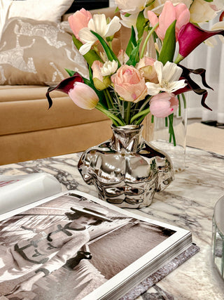 Alexander Male Bust Ceramic Vase - Silver Electroplated on top of a luxurious marble coffee table.