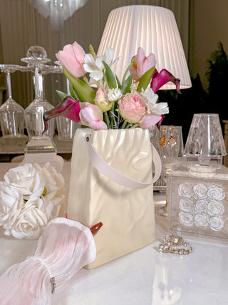 Aria 'Paper Bag' With Leather Strap Ceramic Vase with a variety of florals.