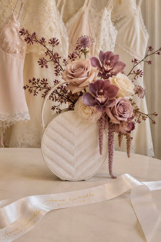 Sofia Round Handbag Resin Vase displayed on a living room mantel