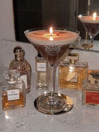 A lit Lux Espresso Martini Candle giving off aromatic espresso scents.