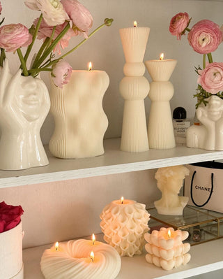 Anaïs Halo 3-Wick Candle on a luxurious shelf next to other Anaïs Candles.