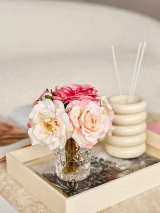 Coco Artificial Roses Arrangement With Patterned Glass Vase atop a silver and yellow acrylic tray.