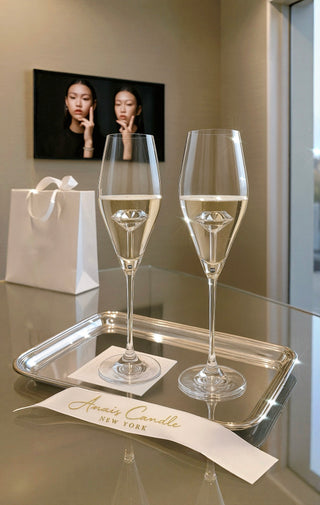 The ‘100-Carat’ Diamond Champagne Flute Set of 2™️ in a luxurious art gallery.