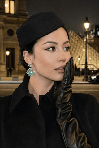 Elegant Emerald Earrings worn by a woman in Paris.