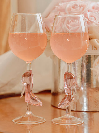 Cindarella’s Glass Slippers Wine Glasses, Set of 2 filled with pink sparkling champagne.