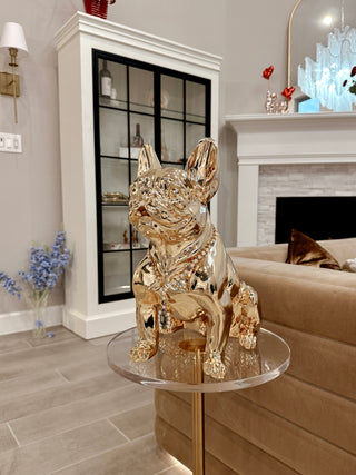 Golden French Bulldog Statue sitting on a table.