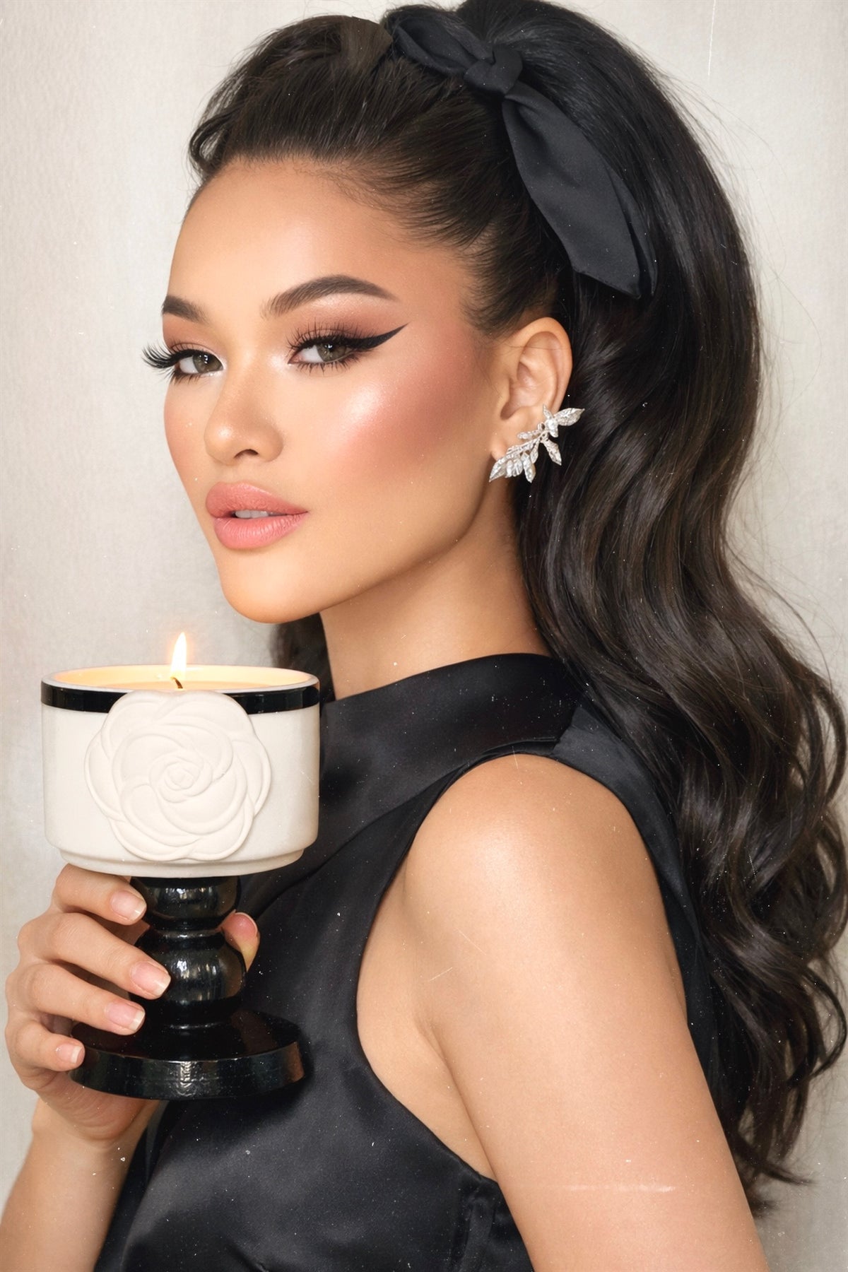 Elegant woman holding the sculptural camellia candle