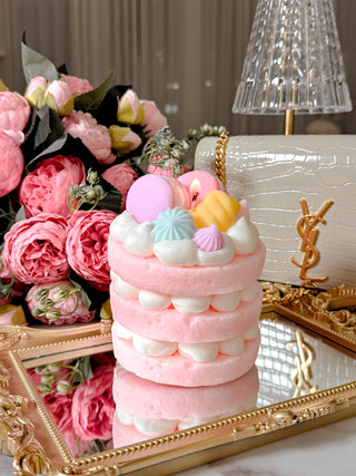 DDreamy Macarons & Cream Tart Candle placed on a Grandeur Gold Mirror Tray with a bouquet.