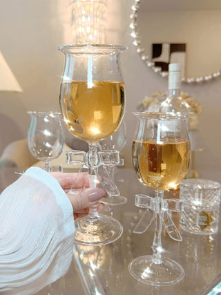 A woman toasting with a Charlotte Bow Wine Glass Cup.