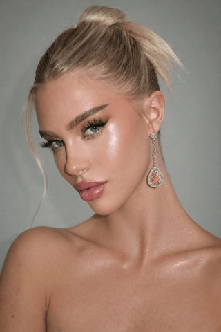 Arya Halo Pear Cut earrings worn on a glamorous girls night out