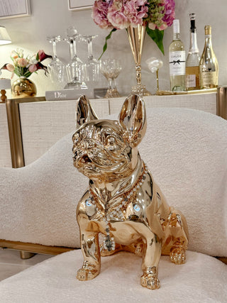 Golden French Bulldog statue sitting on a luxurious sheep dining chair.