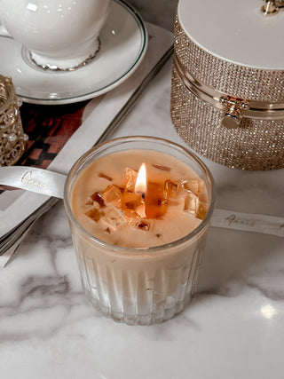 A lit Iced Caffè Candle in front of our beautiful Anaïs white lace ribbon.
