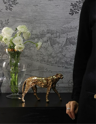 Prestigious Golden Leopard atop a luxurious black entryway table.