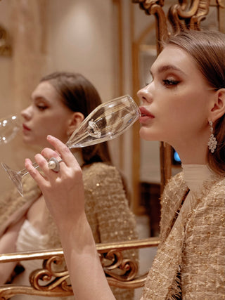 A model drinking from a ‘100-Carat’ Diamond Champagne Flute.