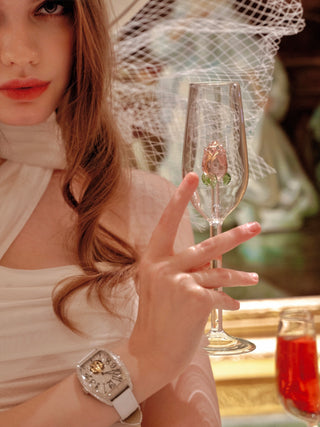 A model gently holding a La Vie En Rose Champagne Glass.
