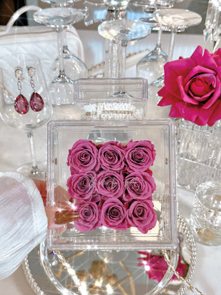 Everlasting Roses in Parfum Box - Plum surrounded by flowers, crystal and glass decorations.