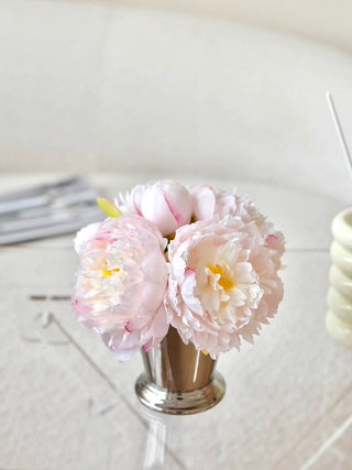 Artificial Peony Arrangement With Sliver Vase atop a glass dining table.