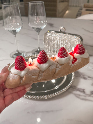 Strawberry & Cream Bread Candle held in a woman's hand.