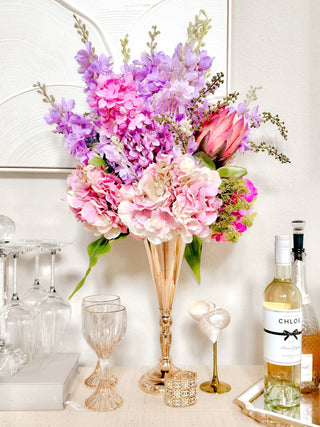 Faux Blooming Floral Arrangement atop a luxurious credenza.