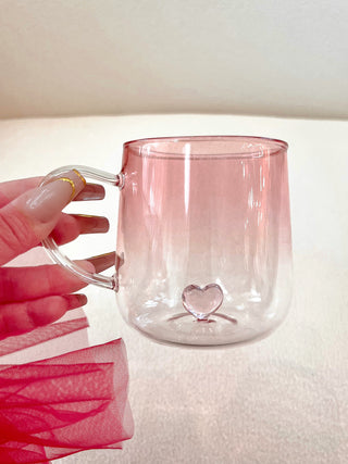 Heart You Glass Cup delicately held by a woman.