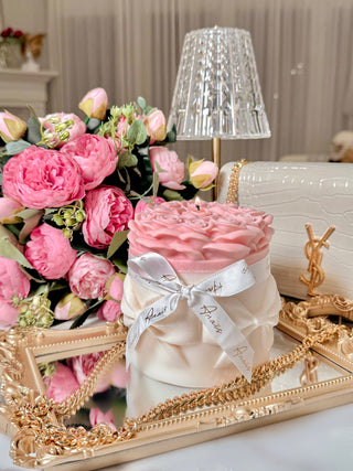 Lavish Rose Bouquet Candle in Pink - XXL placed atop a golden mirror tray.