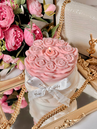 Lavish Rose Bouquet Candle in Pink - XXL surrounded by pink florals and decor.