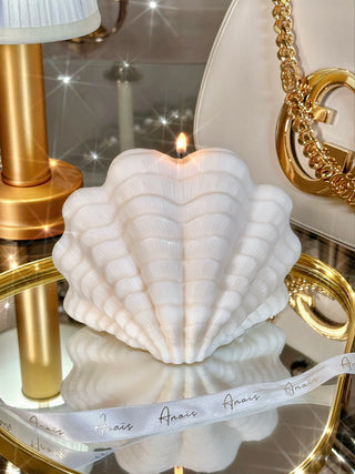 Modern Scallop Shell Candle - XXL placed on a gold mirror tray.