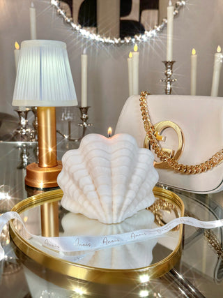 Modern Scallop Shell Candle - XXL surrounded by luxury goods.