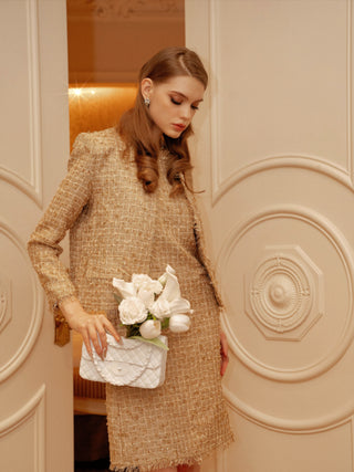 Woman holding an Anastasia Handbag Resin Vase decorated with bloomed white roses.