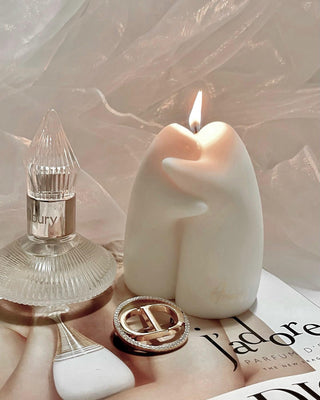 A lit Cuddle Ghosts Candle.