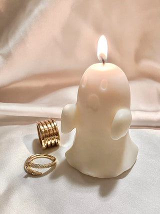 A lit Mini Ghost Candle.