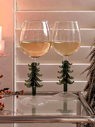 Christmas Tree Glass Cup - Handmade atop a luxurious glass side table.